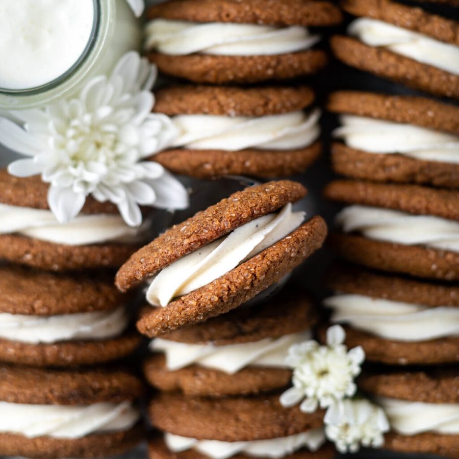 Gingerbread sandwich cookies with vanilla cream filling, warm spices, creamy center, festive delight