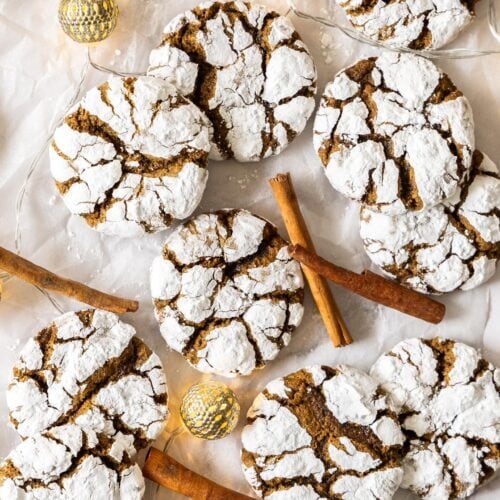 Gingerbread crinkle cookies topped with cinnamon sticks, warm spices, festive charm