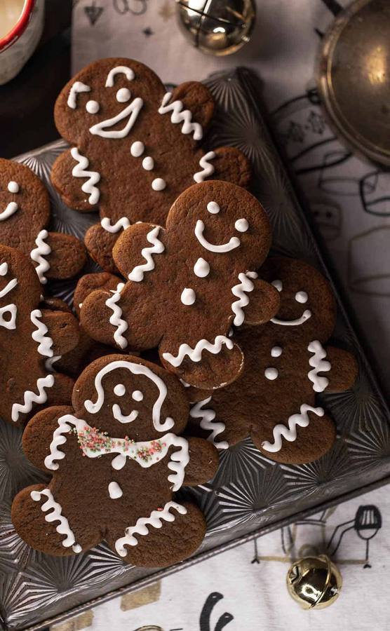 Rich dark chocolate gingerbread men topped with smooth white icing and festive accents