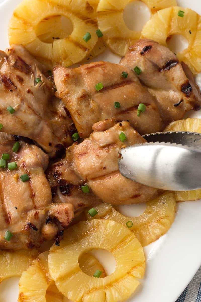 Grilled pineapple chicken with crisp broccoli, tangy dressing, toasted nuts, dried fruit, and cheese.
