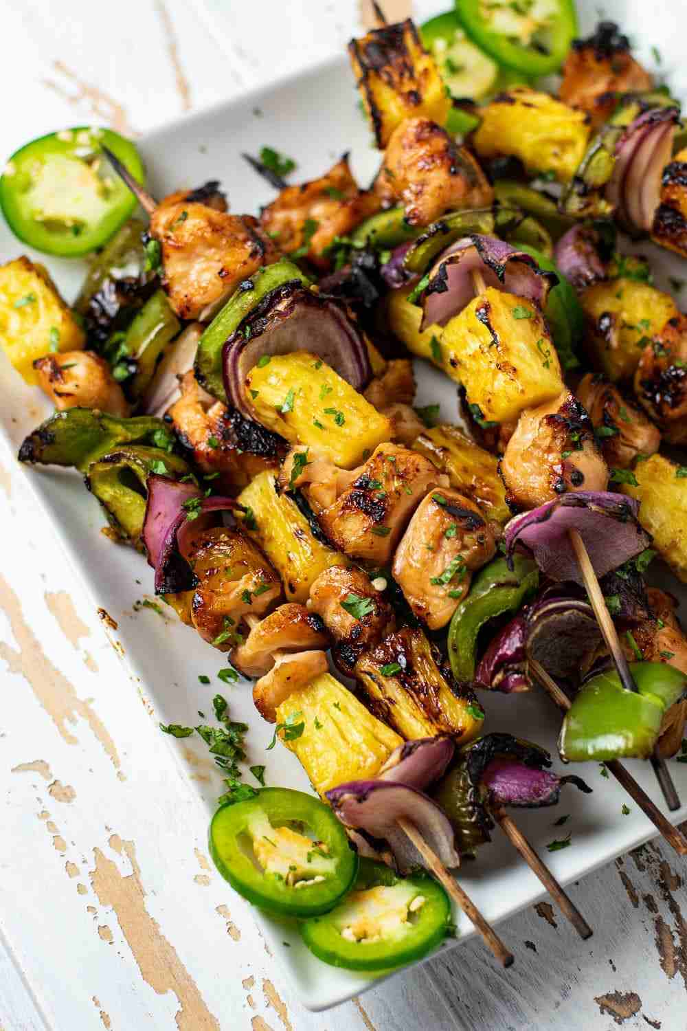 grilled pineapple skewers with crisp broccoli florets, nuts, dried fruit, cheese, and savory dressing