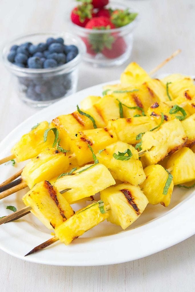 grilled pineapple with crisp broccoli florets, nuts, dried fruit, cheese, and savory dressing