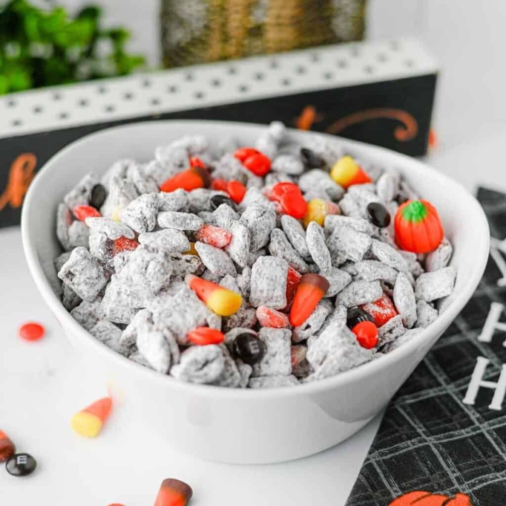 Chex cereal coated in melted peanut butter and chocolate, dusted in powdered sugar and tossed with candy eyes.