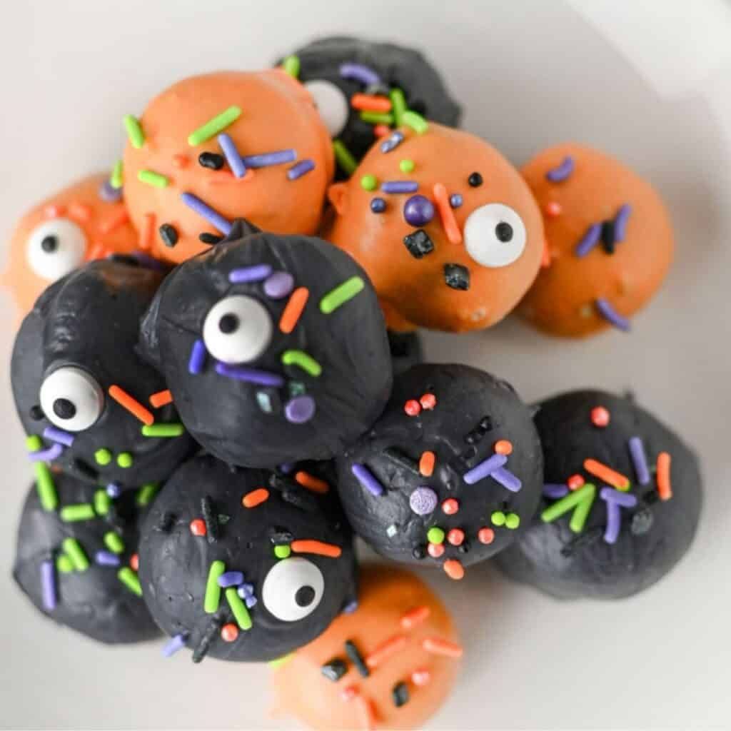 Rich Oreo cream cheese truffle balls dipped in chocolate and decorated with spooky candy eyes.