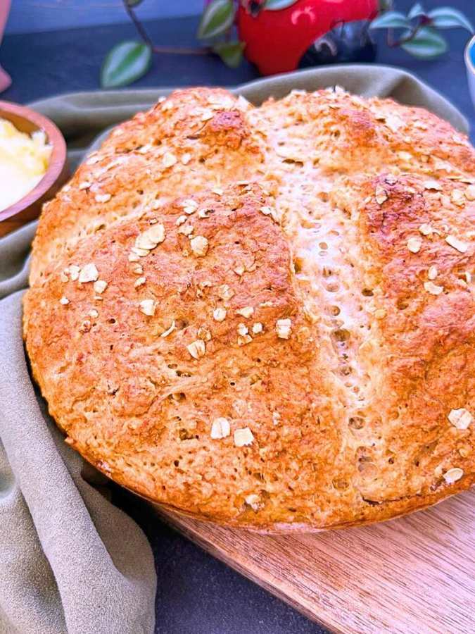 Dark‑golden rustic Irish soda bread loaf with dense, hearty crumb