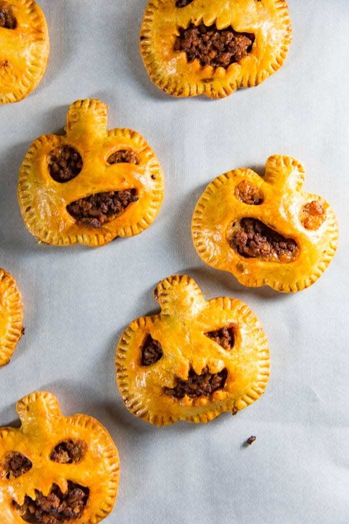 Puff pastry hand pies shaped like jack-o-lanterns filled with seasoned beef and gravy