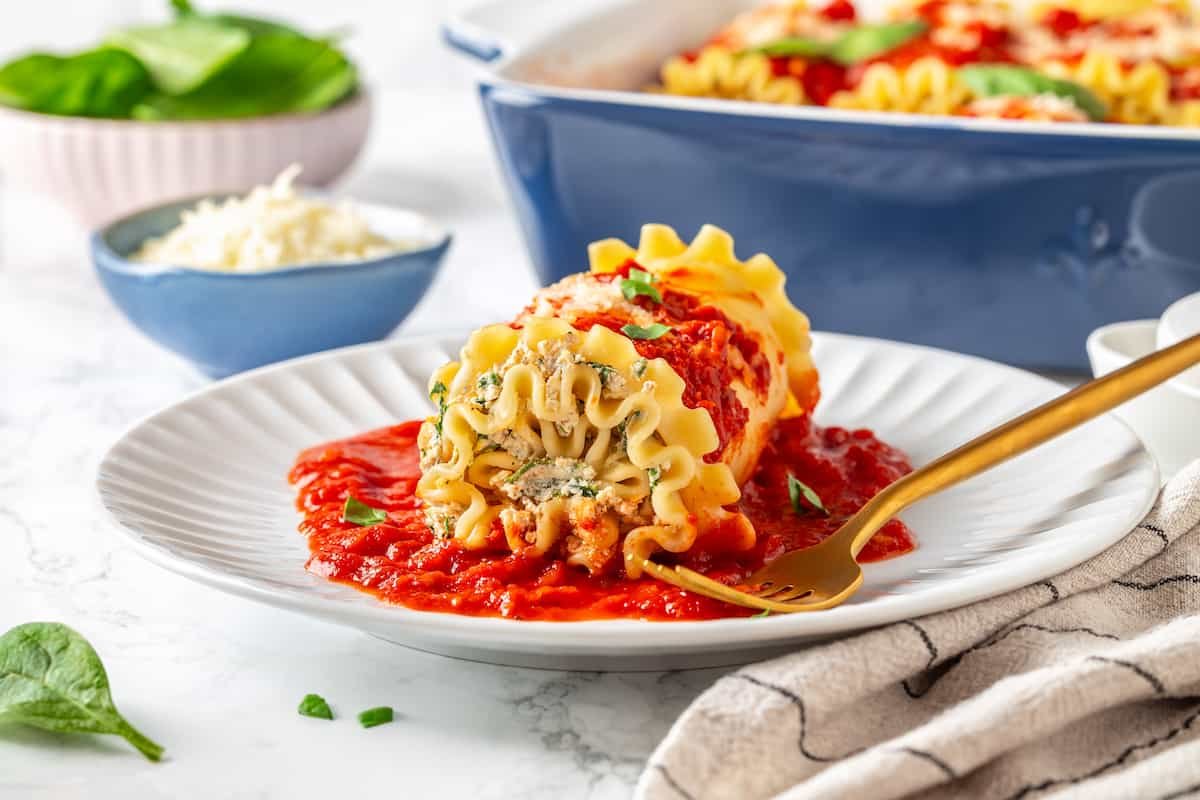 Bite‑size lasagna roll‑ups drenched in marinara, topped with melted mozzarella.