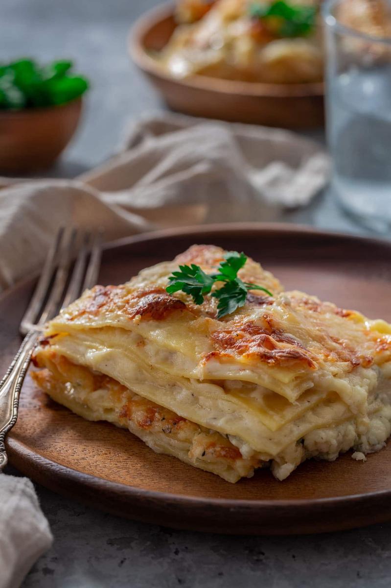 Creamy four‑cheese lasagna with golden crust, layers of pasta, mozzarella, provolone, ricotta, parmesan