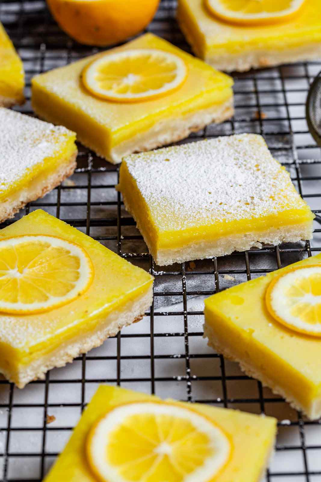 Meyer lemon bars featuring a buttery crust, mellow lemon curd, and powdered sugar topping