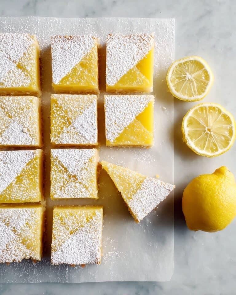 Classic lemon bars with golden shortbread crust, bright lemon curd, dusted with powdered sugar