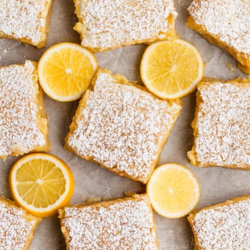 Classic lemon bars with golden shortbread crust, bright lemon curd, dusted with powdered sugar