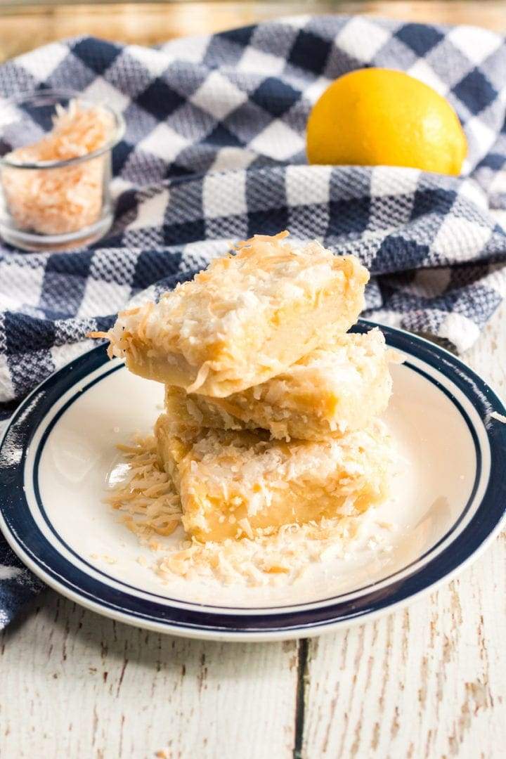 Soft Meyer lemon bars on a golden shortbread crust, lightly dusted with powdered sugar