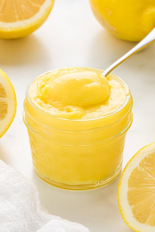 Award‑winning lemon curd in a ramekin, bright citrus, silky, topped with candied lemon peel