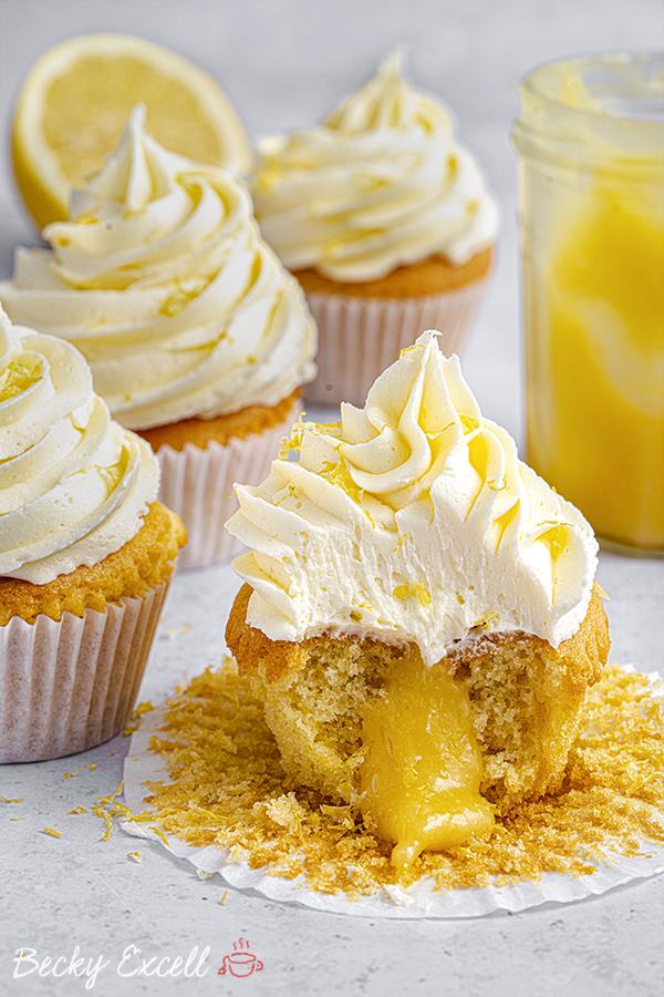 Fluffy gluten‑free lemon cupcakes topped with bright lemon curd and powdered sugar