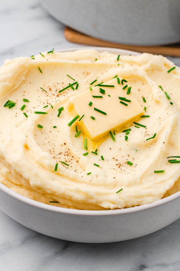 Decadent mashed potatoes pooled with nutty brown butter, golden garlic bits, and fresh parsley
