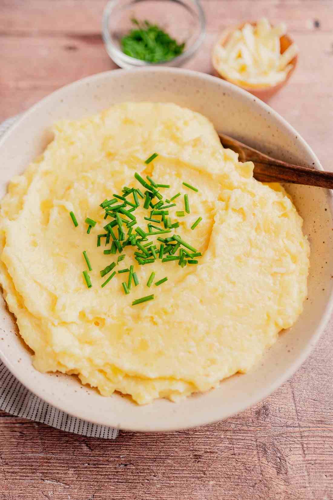 Herbaceous mashed potatoes mixed with melted Parmesan cheese, minced garlic, and fresh rosemary
