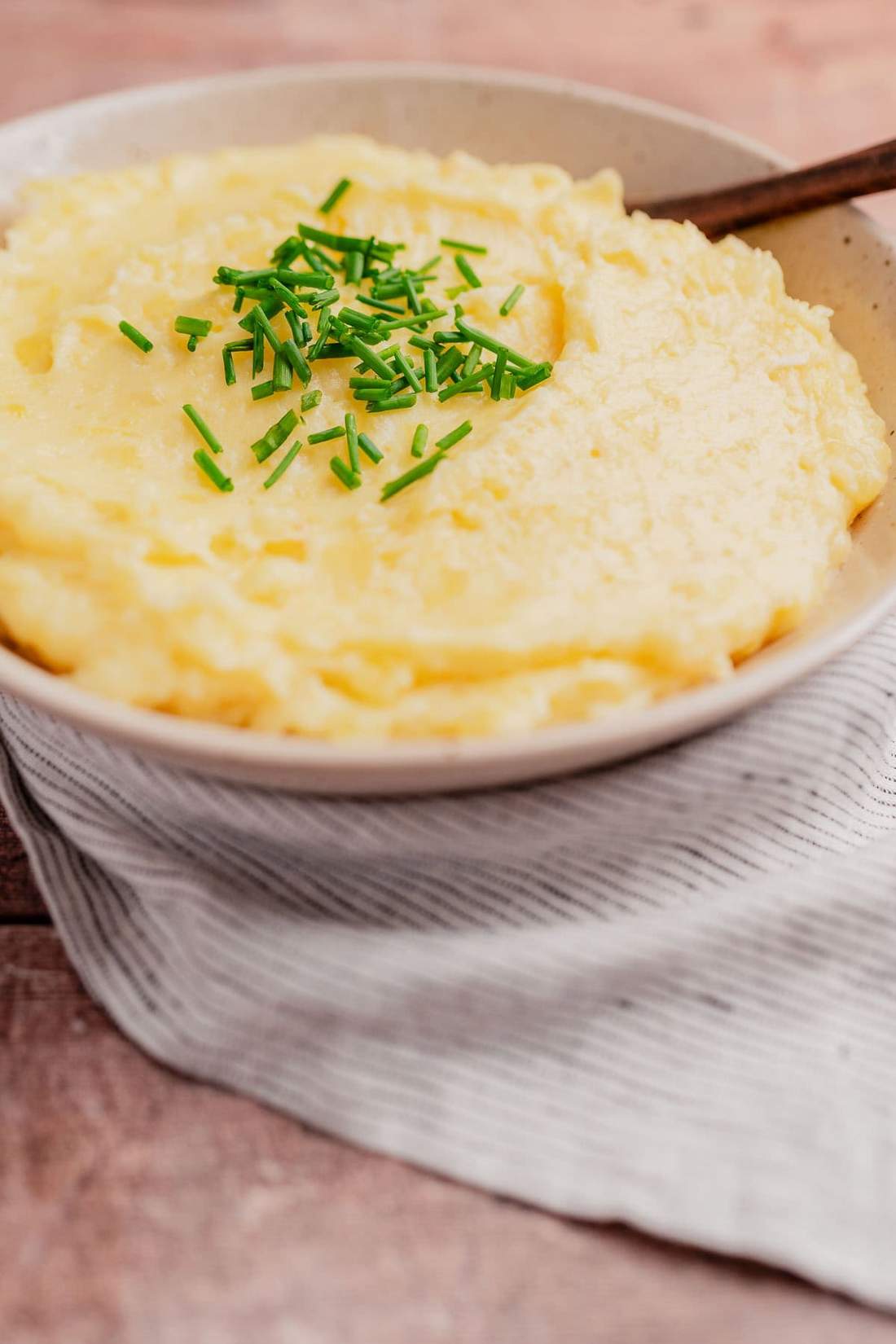 Baked mashed potatoes featuring a golden brown bubbly Parmesan cheese crust in a baking dish