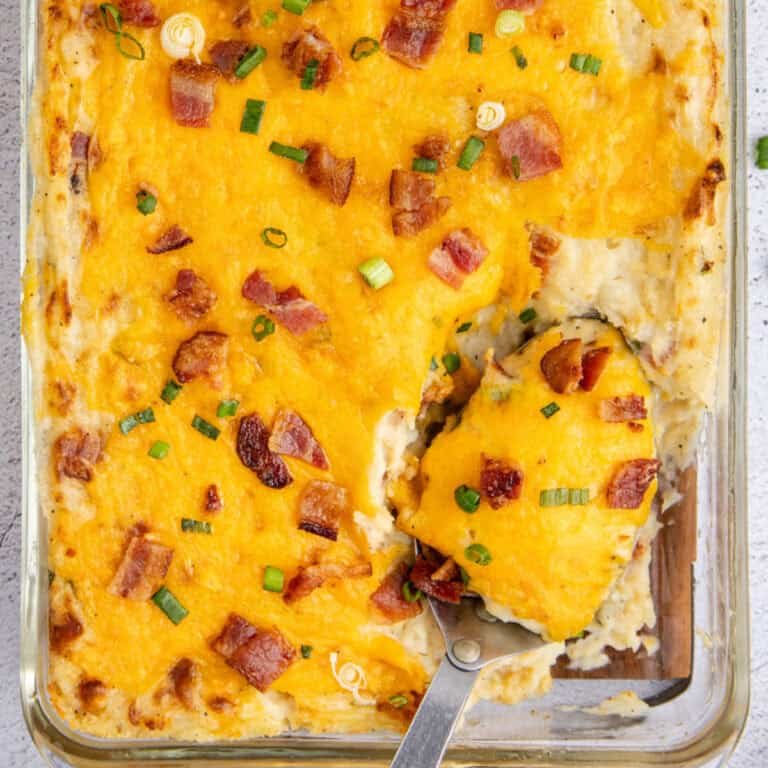 Baked mashed potato casserole with a crunchy golden panko breadcrumb crust, cheddar, and chives