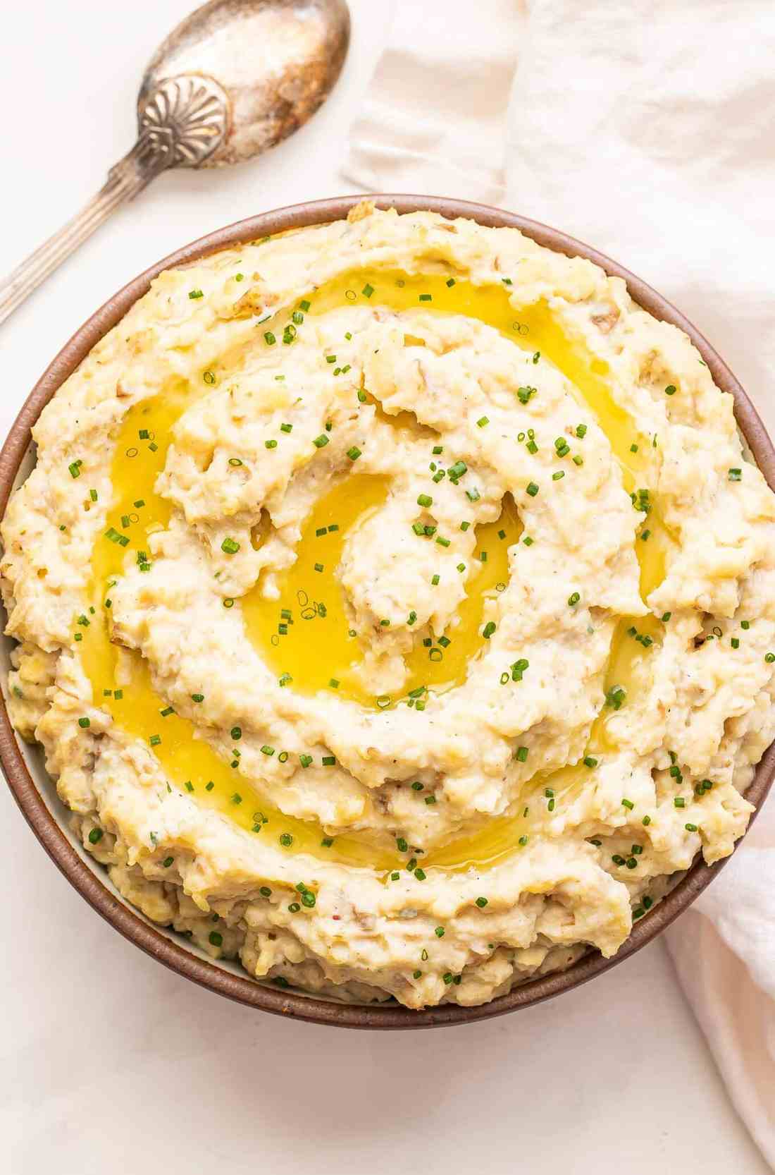 Slow cooker mashed potatoes infused with fresh rosemary, nutty parmesan cheese, and sweet melted butter