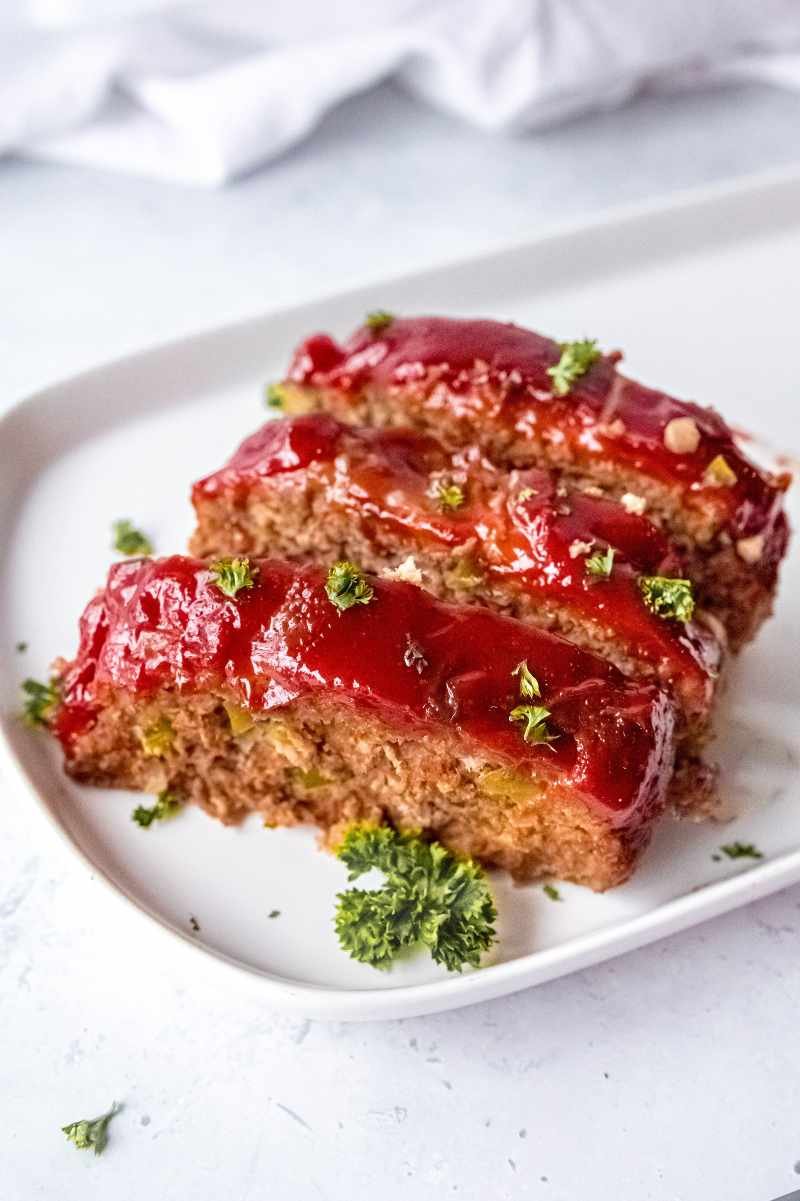 Classic beef meatloaf topped with creamy mushroom sauce, juicy beef, and a golden crust, an indulgent comfort dish