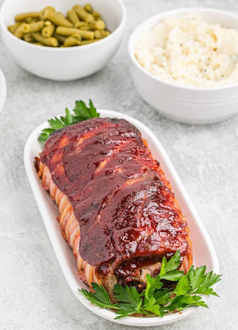 Juicy bacon-wrapped meatloaf with golden glaze, a comforting family favorite