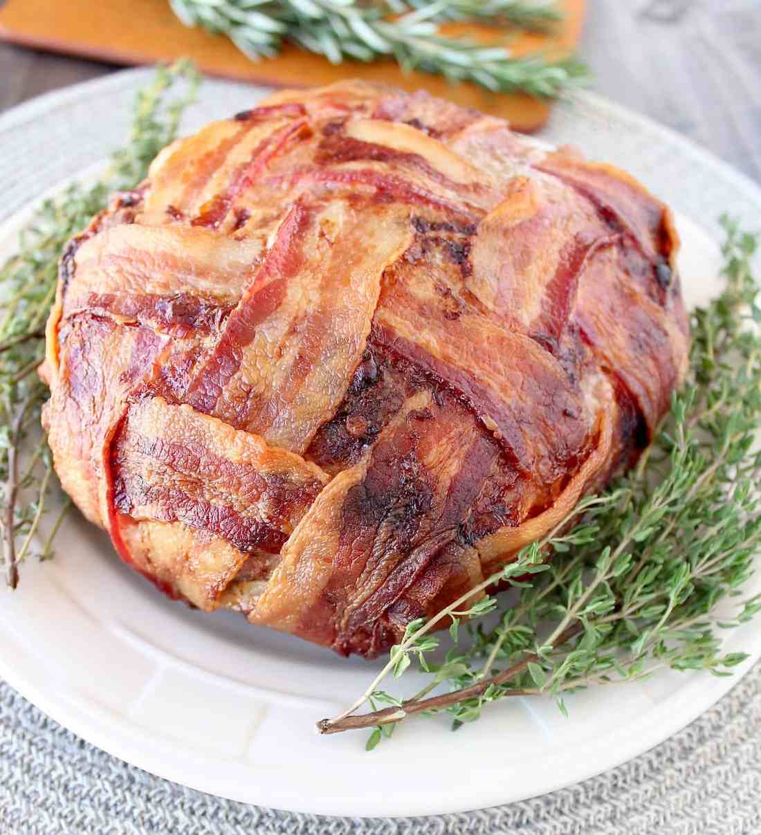 Decadent bacon-wrapped meatloaf with a glossy glaze, perfect for family gatherings