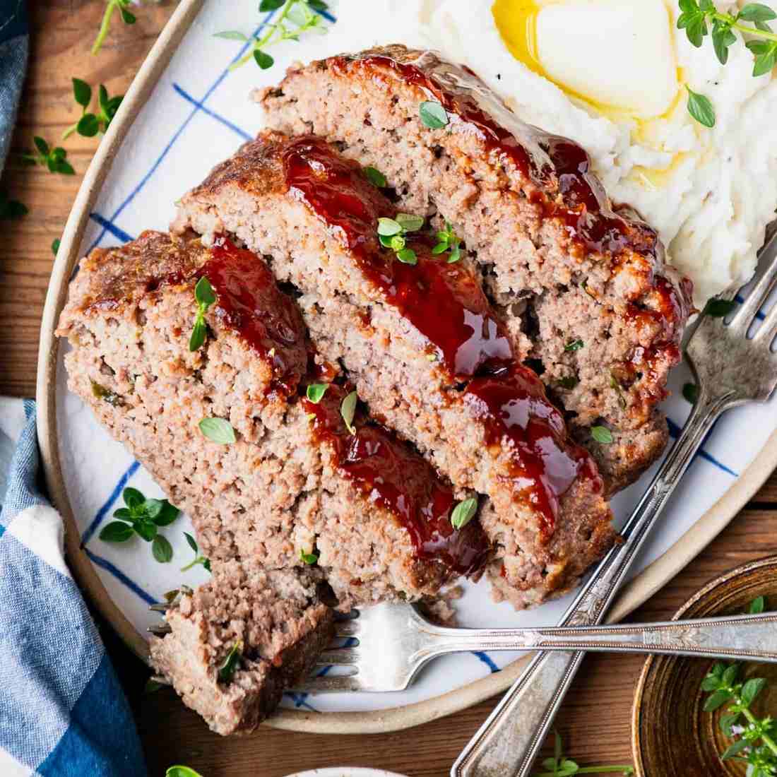 Classic BBQ meatloaf topped with melted cheddar, smoky glaze, and a hearty, juicy interior