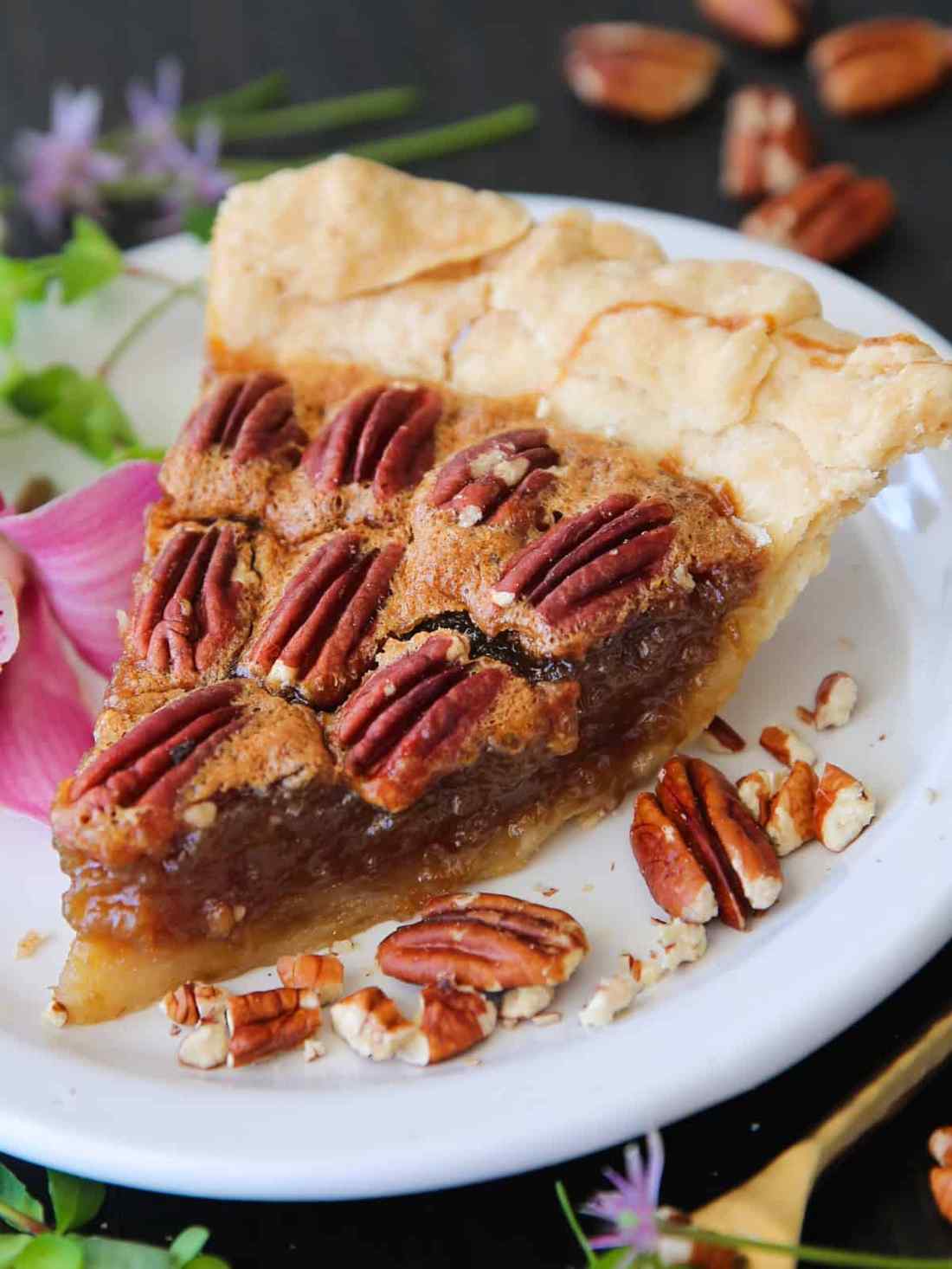 Golden classic pecan pie flecked with aromatic vanilla bean seeds