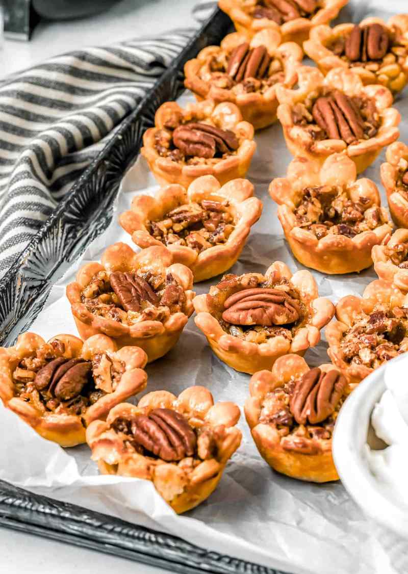 Handheld mini pecan pies drizzled with homemade salted caramel sauce