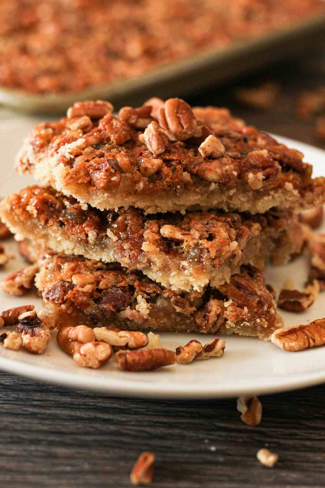 Old fashioned golden classic pecan pie with toasted pecans and rich caramel filling slice