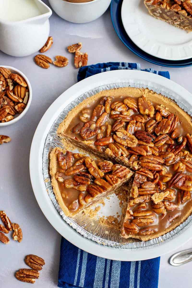 Slice of heirloom southern pecan pie with golden caramel filling and crisp toasted pecans
