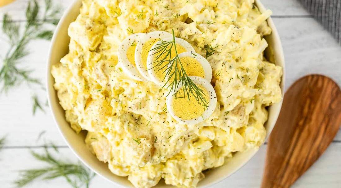 Classic creamy potato salad featuring tender potatoes, creamy mustard dressing, fresh herbs, and crunchy celery