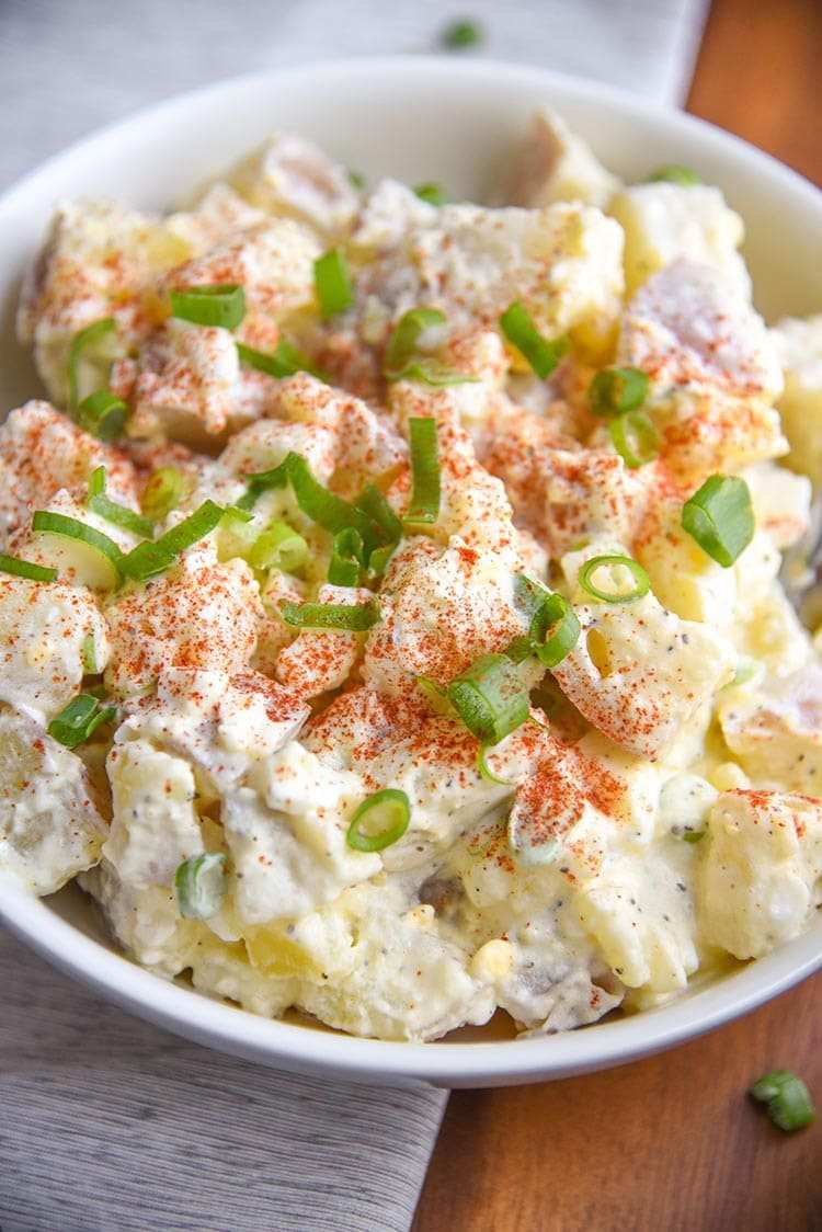 Classic potato salad with tender potatoes, creamy mustard dressing, hard boiled eggs, fresh dill, and crunchy celery
