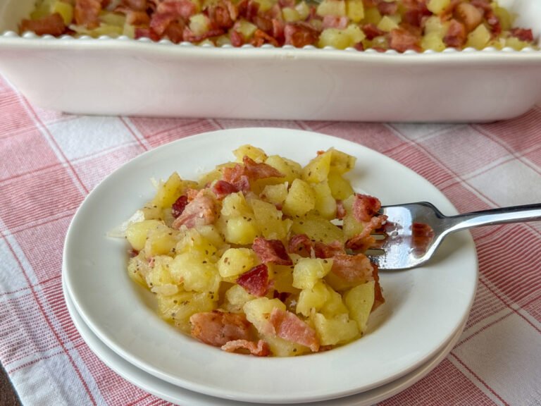 Classic warm German potato salad, fluffy potatoes, sharp vinegar dressing, crispy bacon, chopped chives