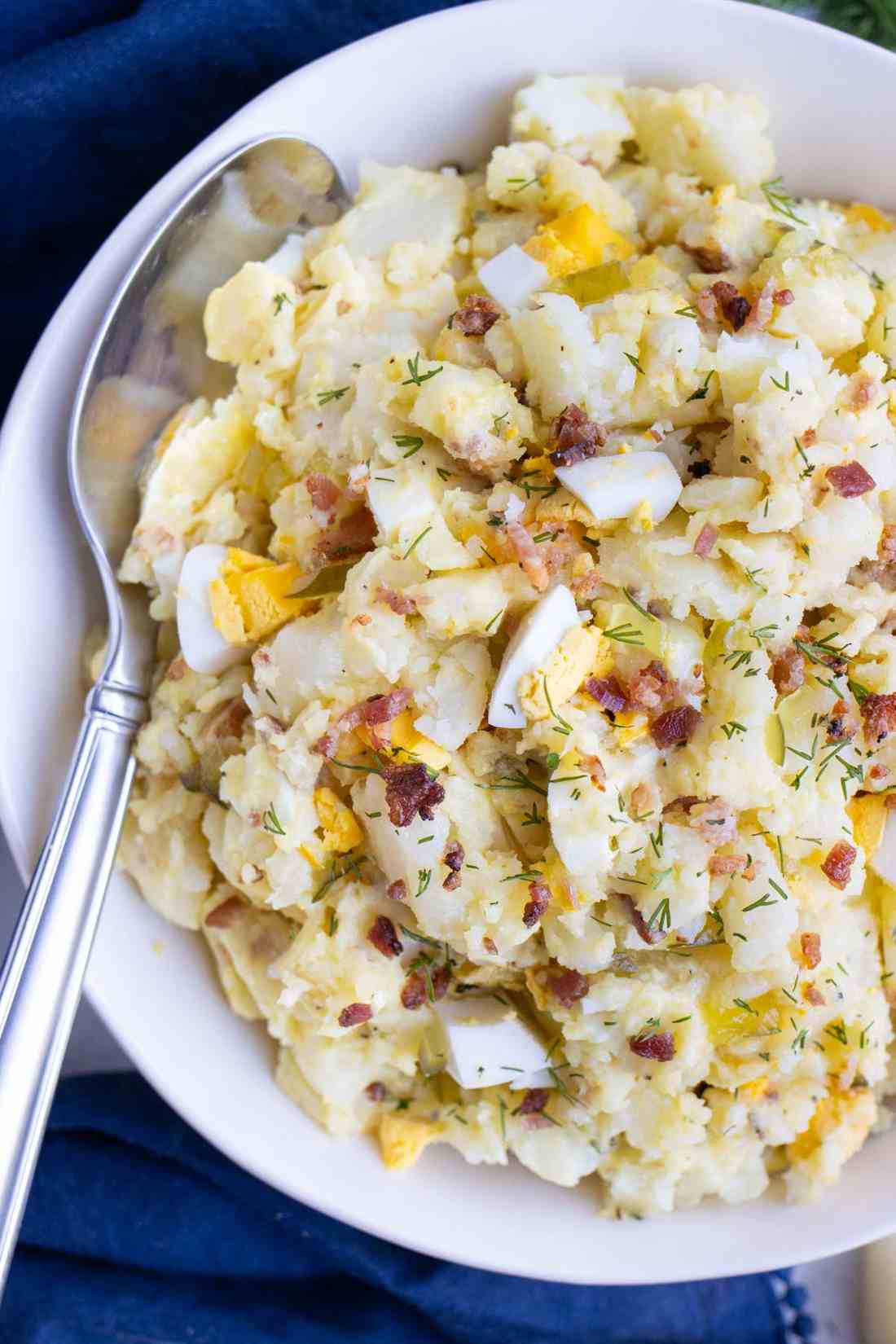 Classic creamy potato salad with tender potatoes, silky mayo dressing, fresh herbs, and crunchy celery