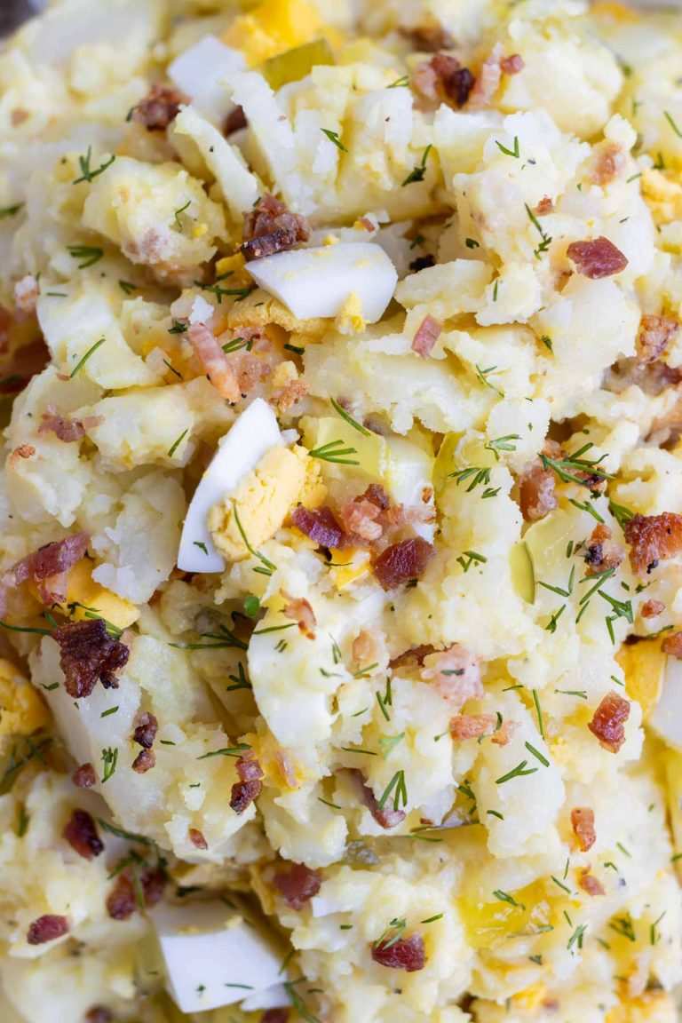 Classic creamy potato salad with tender potatoes, tangy mayo dressing, fresh herbs, and crunchy celery