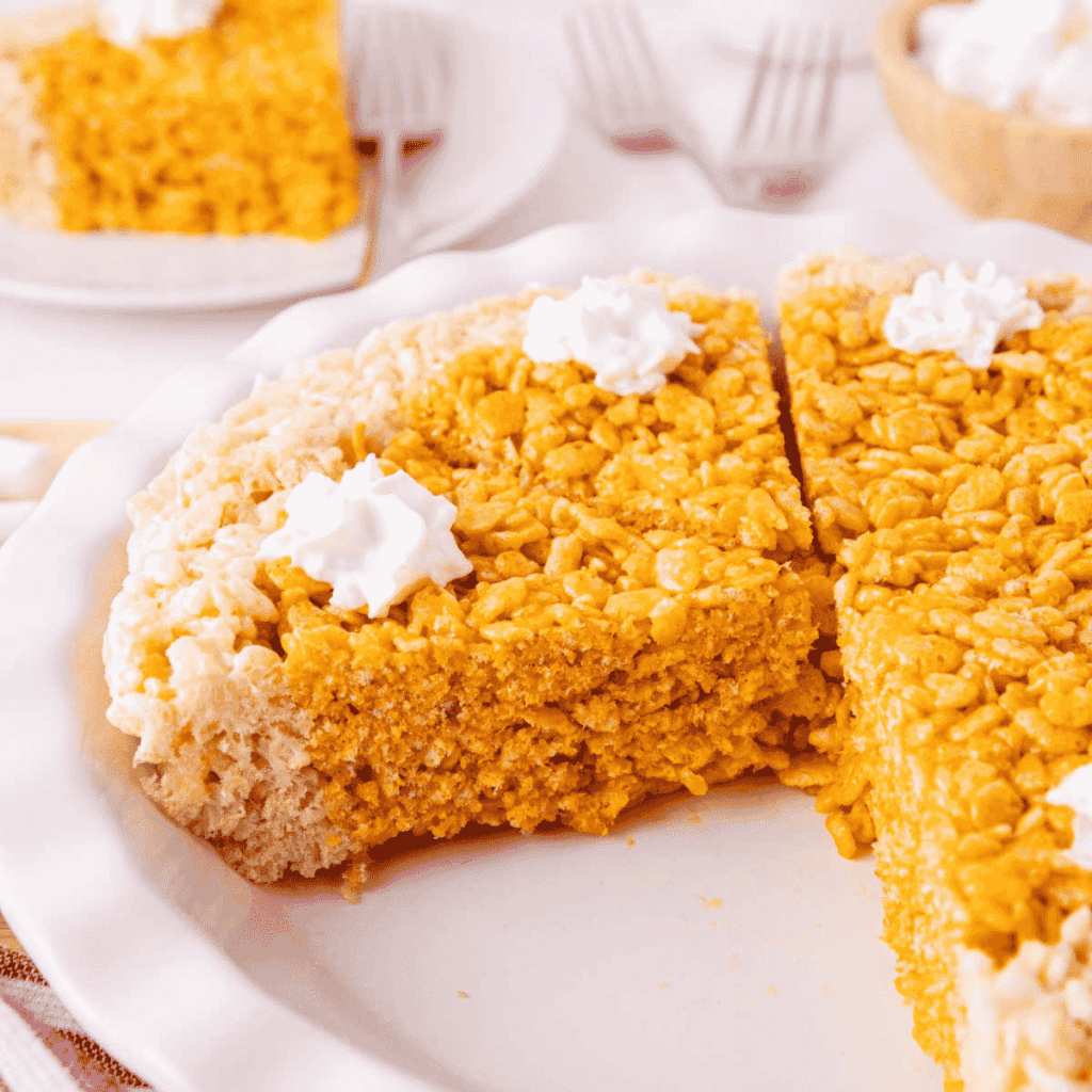 Chewy marshmallow Rice Krispies cereal squares tinted autumn orange and flavored with warm pumpkin pie spice.