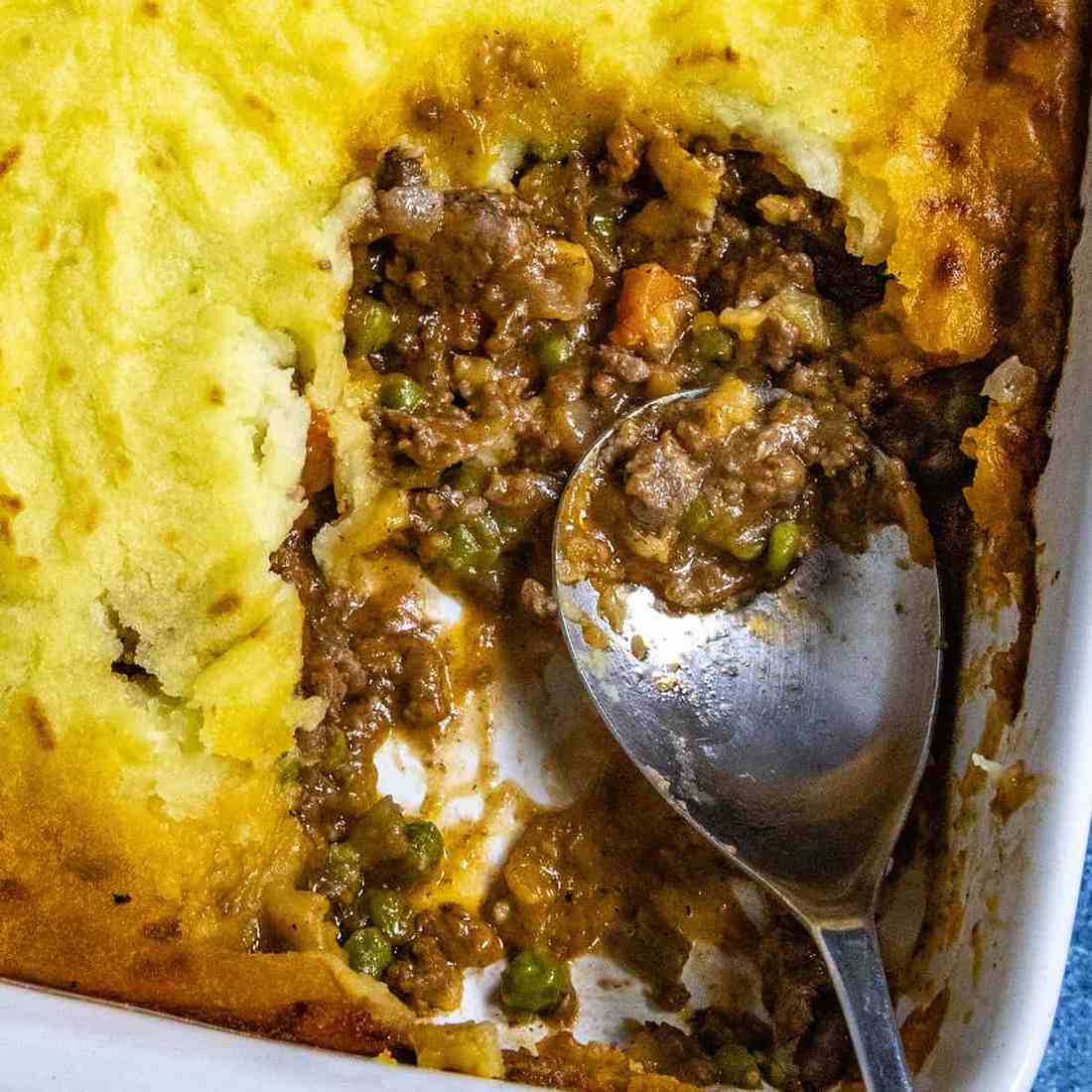 Golden mashed potato topped homestyle shepherd's pie with savory beef filling, bubbling cheese