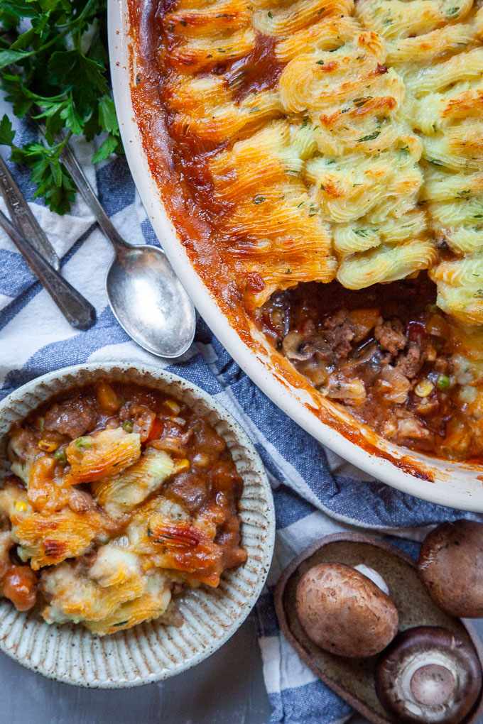 Golden mashed potato topped homestyle shepherd's pie with savory beef filling, bubbling cheese