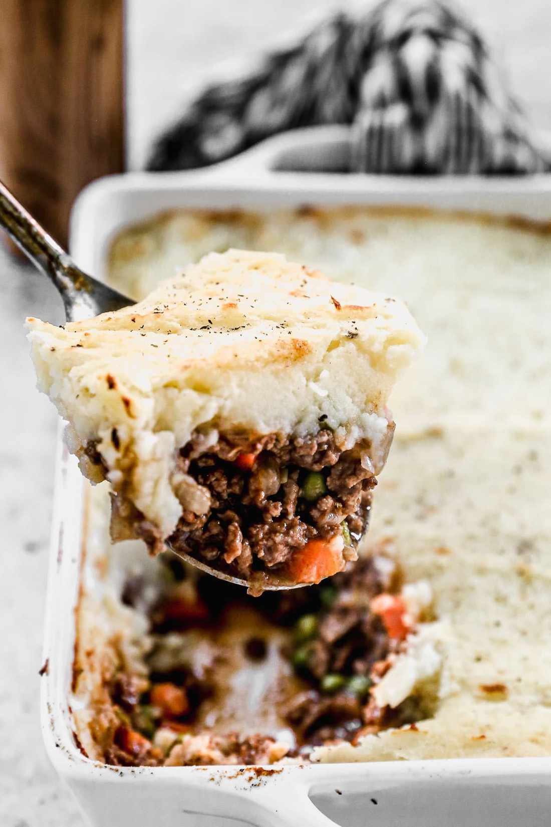 Hearty shepherd's pie, creamy potato crown, savory beef filling, bubbling cheese, warm casserole dish