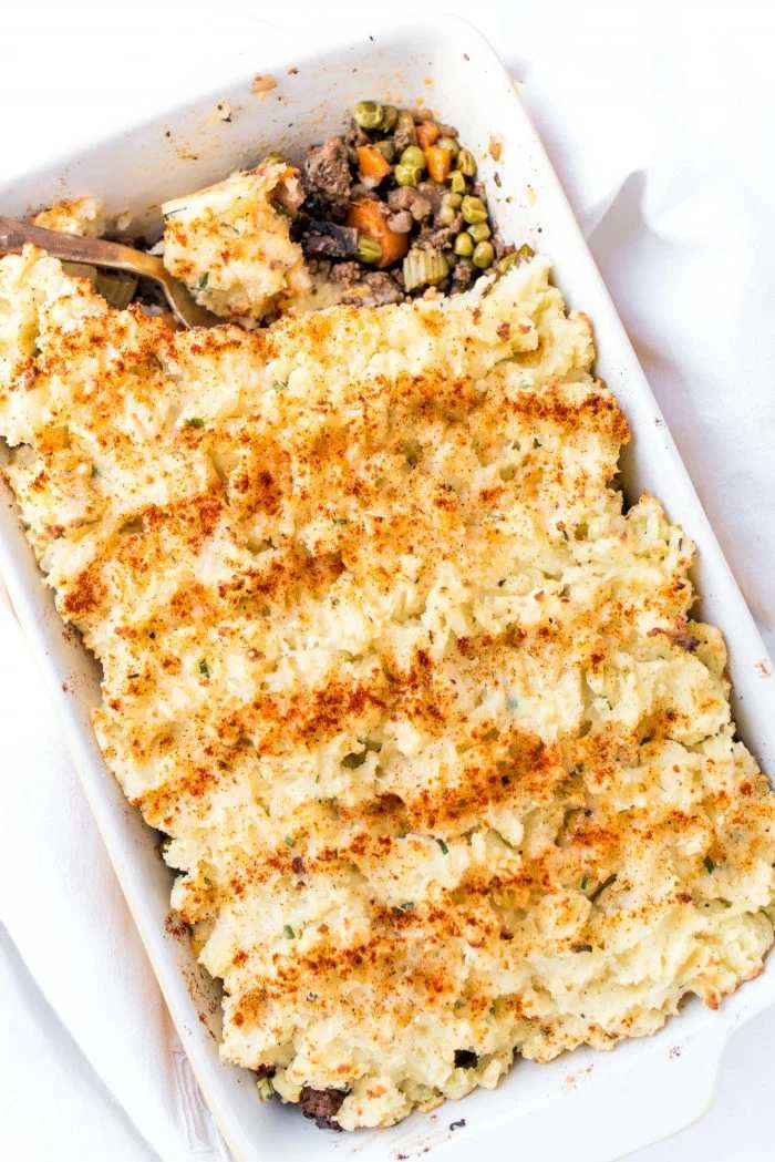 Hearty shepherd's pie, creamy herb‑mashed topping, savory beef filling, bubbling cheese, warm casserole dish