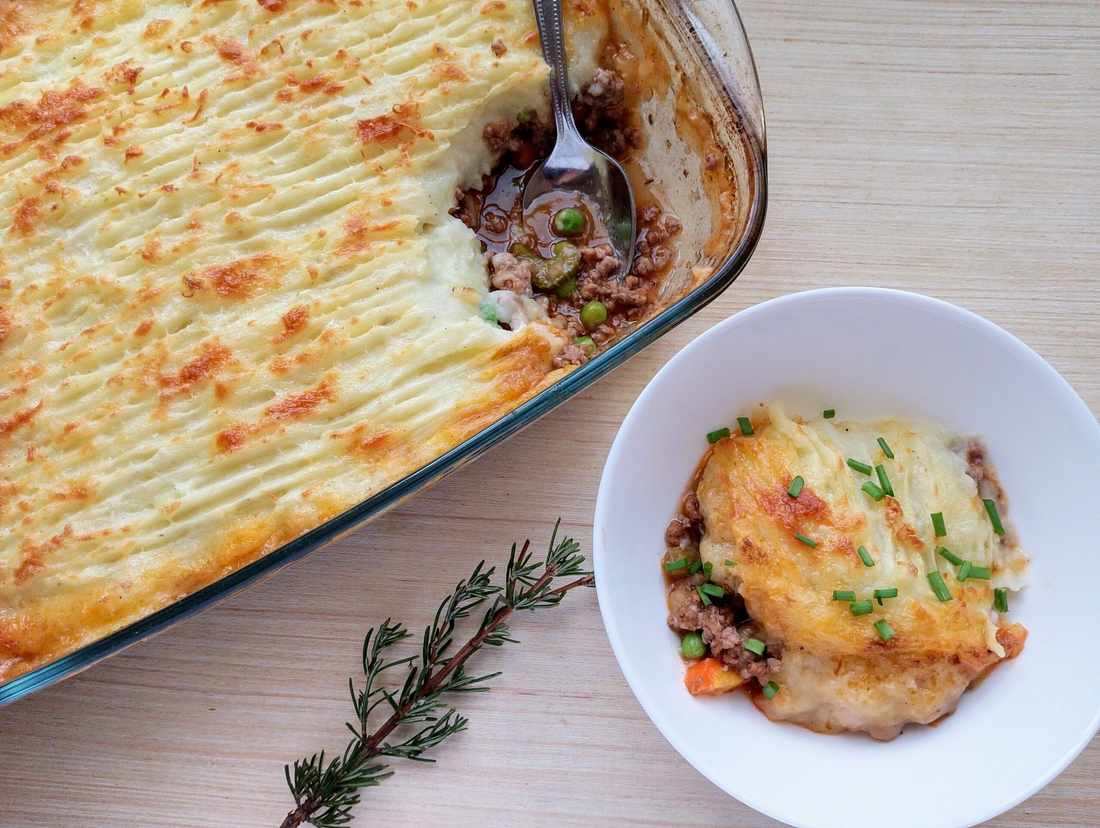 Golden mashed potato crowned ground beef cottage pie with savory filling, bubbling cheese, warm casserole