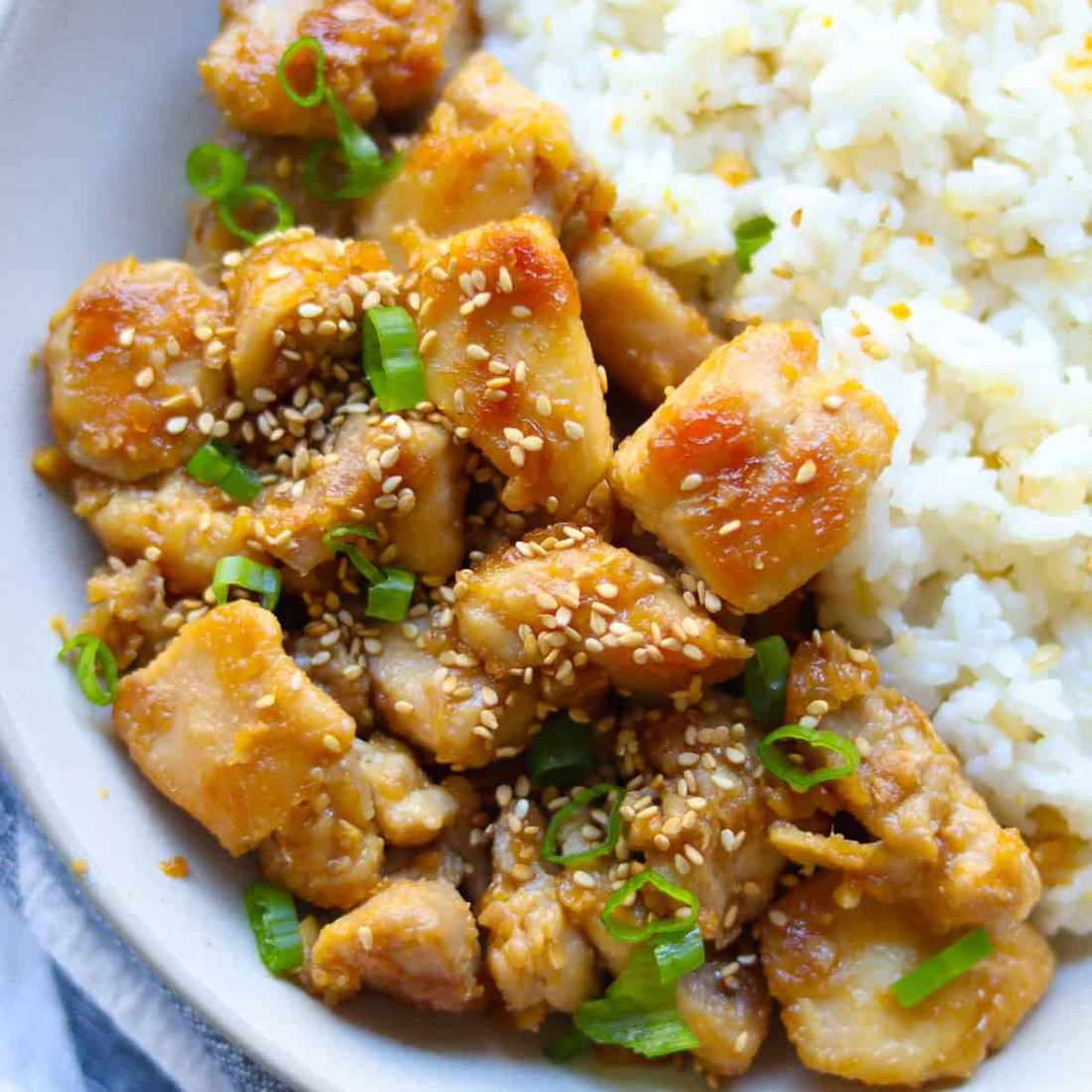 Orange‑glazed skinny chicken atop crisp Asian slaw with citrus vinaigrette