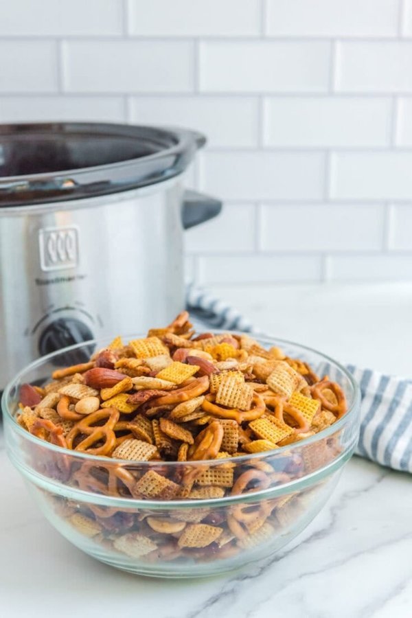 Classic Chex party mix with pretzel sticks, mixed nuts, and buttery garlic glaze