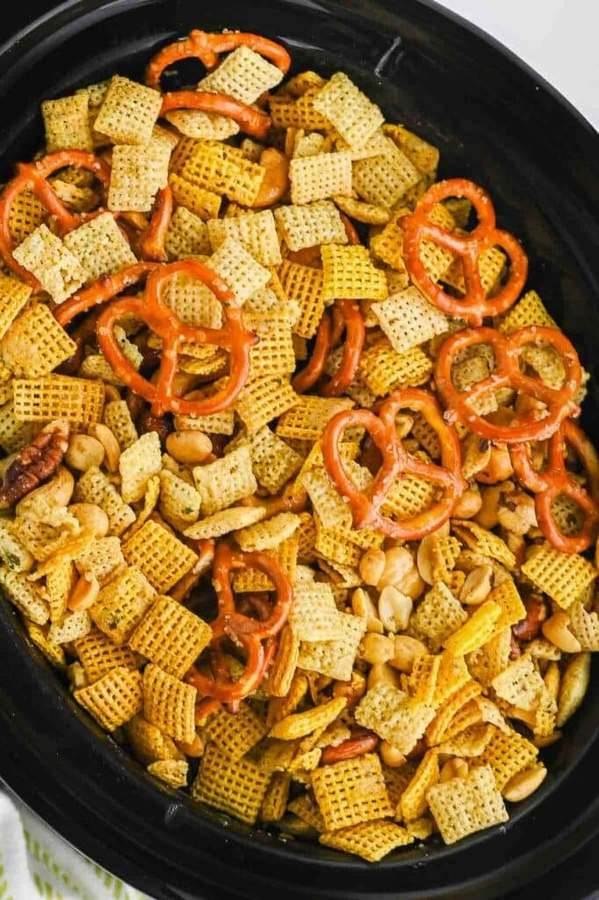 Garlic Parmesan Chex mix with pretzels, walnuts, butter, and savory cheese seasoning