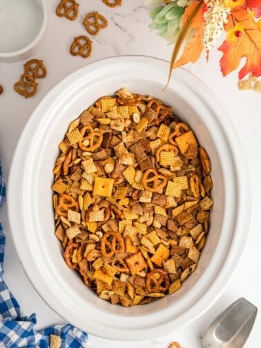 Sweet chili Chex mix with pretzels, peanuts, butter, and a sticky glaze