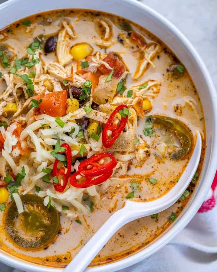 Creamy chipotle lime chicken tortilla soup with smoky broth, shredded chicken, crunchy tortilla strips, avocado, and lime