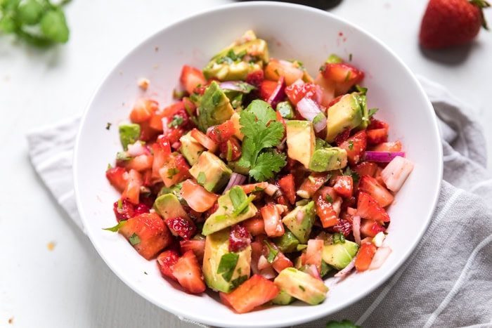 Strawberry avocado salsa with fresh strawberries, avocado, cilantro, and lime, served in a bright bowl