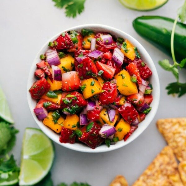 Classic fresh strawberry salsa with diced strawberries, red onion, lime, cilantro, and a splash of honey