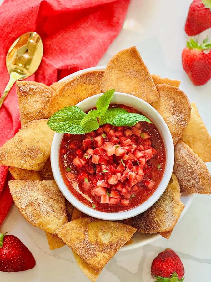 Sweet strawberry dessert salsa with strawberries, cinnamon chips, and a drizzle of vanilla yogurt